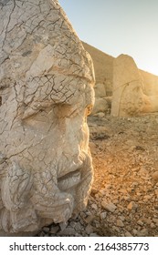 Antique statues at sunrise on Nemrut mountain in Turkey. Ancient stone head close-up at the top of 2150 meters high Mount Nemrut, Eastern Anatolia, Turkey