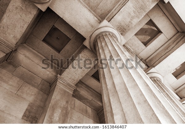 Antique stone\
column of a old building\
close-up.