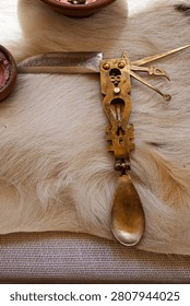 Antique style folding brass multitool featuring a spoon and knife, illustrating historical utility, ingenuity, and multipurpose survival.