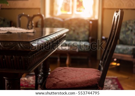 Antique table and chair. Classic room interior. Victorian furniture for sale.