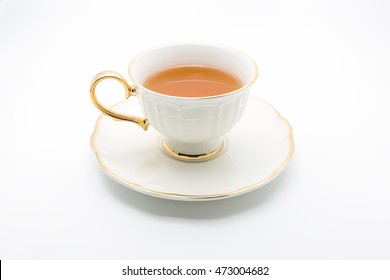Antique tea cup full of tea on white background
