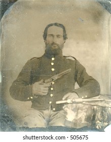Antique tintype of Civil War soldier holding gun. Around 1860. Lots of intact wear and grunge.