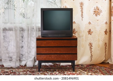 An Antique TV Stands On An Old Wooden Cabinet, Antique Design In A 1980s And 1990s Style Home. Interior In The Style Of The USSR.