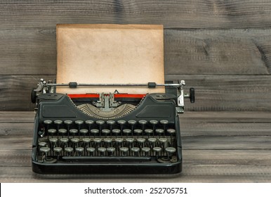 Antique Typewriter With Grungy Textured Paper Page On Wooden Table. Vintage Style Still Life