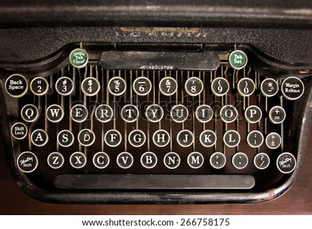  an antique typewriter on a wooden table 
