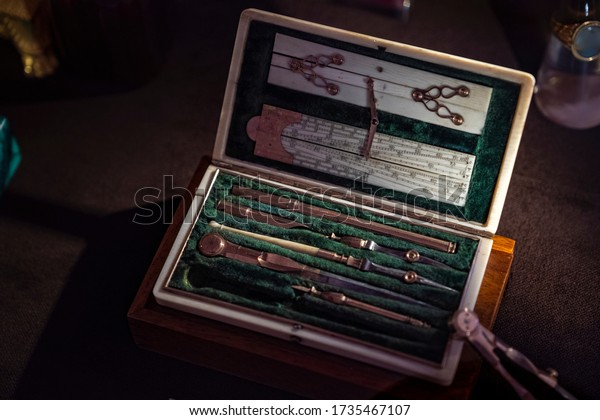 Antique\
unique set of drawing tools in an emerald green velvet case. It is\
used for neat measurement and layout of drawings. Luxury giftbox or\
case, lots of metal tools, linea or ruler tool.\
