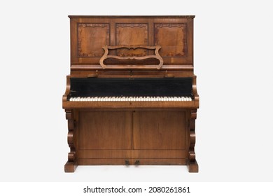 Antique upright piano isolated on white background.