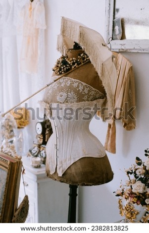 Antique Victorian corset and umbrella in a French antique store, with nice creamy colors and an old Victorian tone