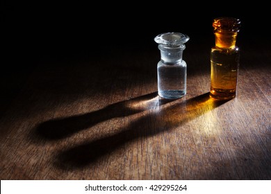 Antique and vintage glass bottles for pharmaceutical use of "Teinture d'iode" (means Tincture of iodine), that is an antiseptic medicine, isolated on a wooden background.