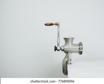 Antique, Vintage Meat Grinder On A White Wooden Table