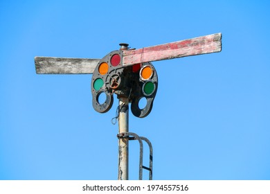 antique vintage retro old rusting railroad train tracks light signal with red orange and green lens