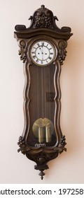 Antique Wall Clock With A Pendulum