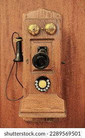 Antique wall mounted wood telephone-fiddleback cathedral type with rotary dialer, switch hook, OST pony receiver, transmitter with black metal mouthpiece, two ringers, and crank. Sydney-NSW-Australia.