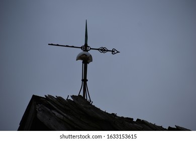 Antique Weather Vein Atop Rustic Barn