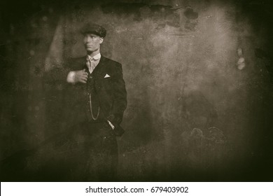 Antique wet plate photo of 1920s english gangster wearing suit and flat cap.