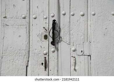 Antique Whitewashed Wooden Door With Matching Studs And A Sol Key Shaped Handle In Trinidad, Cuba. 