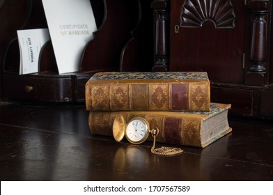 Antique wood desk containing genealogy deeds and certificates, pocket watch and books. - Shutterstock ID 1707567589