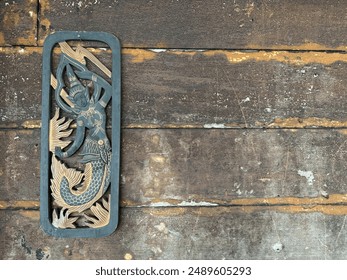 Antique wood surface and carved angel decorate the wall. - Powered by Shutterstock