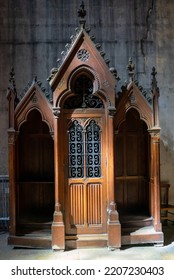 Antique Wooden Confessional Box In Dark Wood In A Church. Religious, Christian Custom. Making The Confession