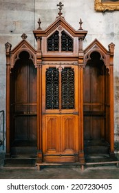 Antique Wooden Confessional Box In Dark Wood In A Church. Religious, Christian Custom. Making The Confession