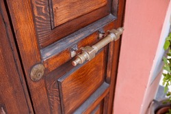 Antique Wooden Door With Gilded Handle. Metal Door Handle Close-up Photo.