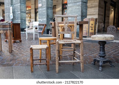 Antique Wooden Stuffed Chair And Small Benches For Sale On The Street.