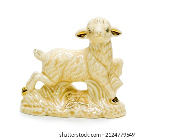 Antiques, art, collectibles. Swap meet. Isolated over white background. Goat figurine, glazed ceramic