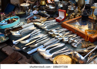 Antiques on flea market or festival, vintage silver cultery - spoons, knifes, forks and other vintage things. Collectibles memorabilia and garage sale concept