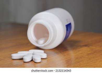 Anti-Radiation Pills, Iodine tablets, tablets for radiation protection on the wooden table with a white medical jar