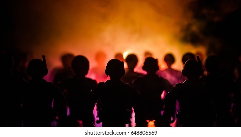 Anti-riot police give signal to be ready. Government power concept. Police in action. Smoke on a dark background with lights. Blue red flashing sirens. Dictatorship power - Shutterstock ID 648806569