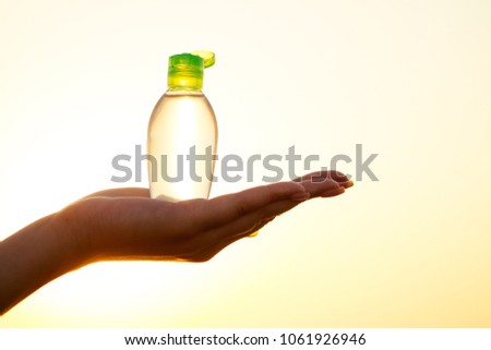antiseptic in the hands of a woman on the beach