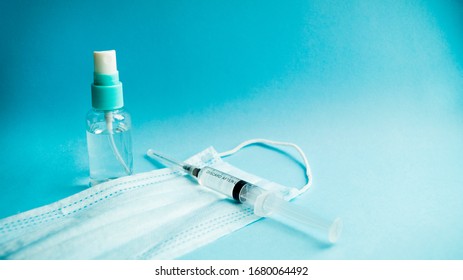 Antiseptic, medical mask and syringe on a blue background. Prevention, protection and treatment against viruses. Healthcare and medicine. Coronavirus, covid -19. - Shutterstock ID 1680064492