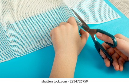 Anti-Slip Underlay to Prevent Rugs from Moving, Cutting Rubber Mesh for Placing Under Carpet on Blue Background Top View - Shutterstock ID 2234726959