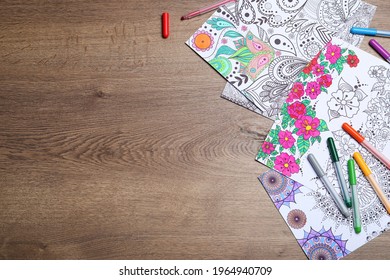 Antistress Coloring Pages And Felt Tip Pens On Wooden Table, Flat Lay. Space For Text