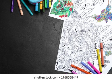 Antistress Coloring Pages And Felt Tip Pens On Black Table, Flat Lay. Space For Text