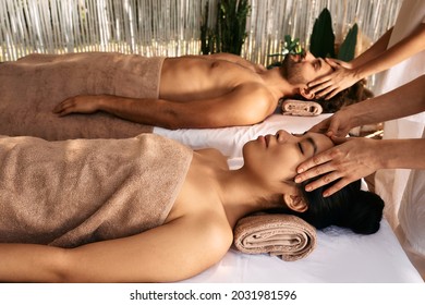 Anti-stress head massage for a loving couple at resort, close up. Beautiful couple getting head massage and enjoys relaxing at spa