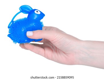 Antistress rubber bunny toy in hand on white background isolation