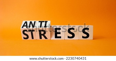 Antistress vs stress symbol. Concept words Antistress vs stress on wooden cubes. Beautiful orange background. Antistress vs stress concept. Copy space