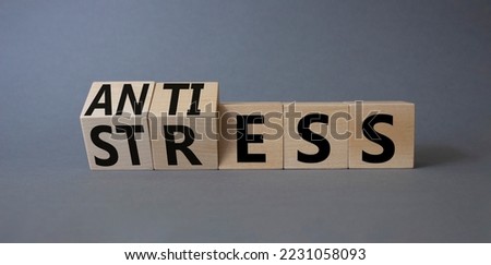 Antistress vs stress symbol. Concept words Antistress vs stress on wooden cubes. Beautiful grey background. Antistress vs stress concept. Copy space