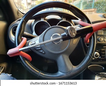 Anti-Theft Car Steering Wheel Lock Car Security. Black And Red Colors. Close Up View