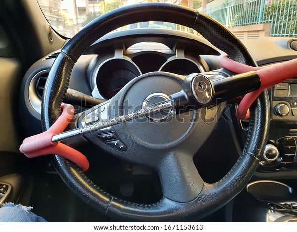 Anti-Theft Car Steering Wheel Lock Car Security.\
Black And Red Colors. Close Up\
View
