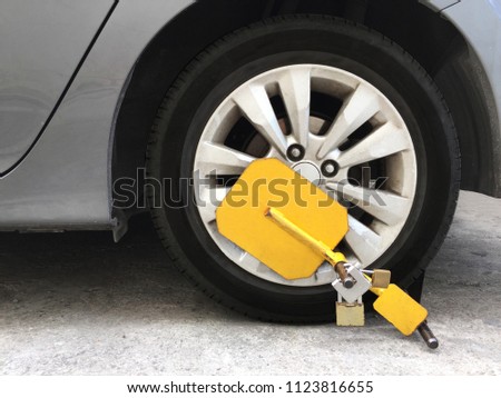 Anti-Theft Tire Wheel lock with yellow clamp. 