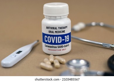 Antiviral Therapy Oral Medicine For Covid-19 Coronavirus With Pills (capsule), Thermometer, And Stethoscope.