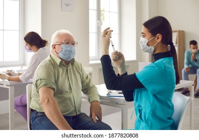 Antivirus vaccination for older people. Covid-19, pneumonia or flu preventive measures. Male senior citizen waiting to receive his vaccine. Asian doctor in face mask administering shot to mature man - Powered by Shutterstock