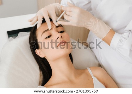 Anti-wrinkle therapy using botulinum toxin smooths deep creases. Non-surgical botulinum toxin treatment for the forehead area. Glabellar Botulinum Toxin Injection close-up