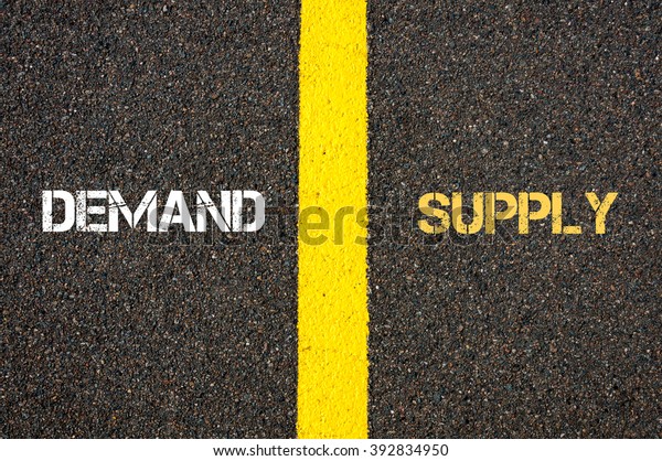 Antonym\
concept of DEMAND versus SUPPLY written over tarmac, road marking\
yellow paint separating line between\
words