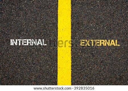 Antonym concept of INTERNAL versus EXTERNAL written over tarmac, road marking yellow paint separating line between words