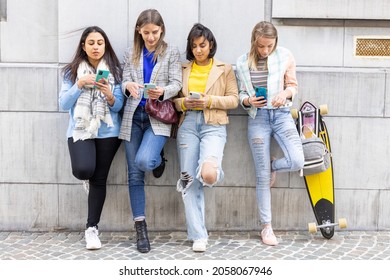 Antwerp, Belgium, 05-21-2021, Group Of Beautiful Young Female Friends Of Different Race Using Smart Mobile Phones App, Teenagers Addiction To New Technology Trends, Showing Concept Of Youth, Tech