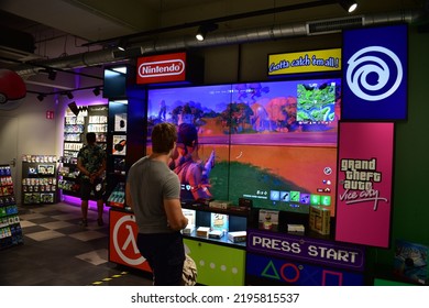 ANTWERP, BELGIUM - 08 28 2022: Young Man Playing Fortnite Inside The Video Game Store 