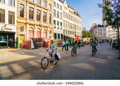 Antwerp, Belgium - 26/09/2017: Young Kids Riding A Bike Through Old Parts Of City